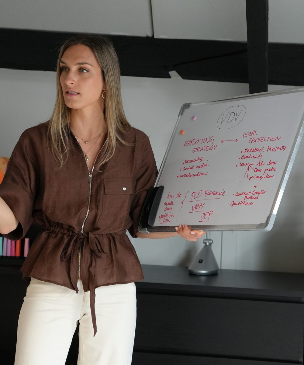 Elisa Volpi giving a training, mapping marketing strategy and legal protection on a whiteboard